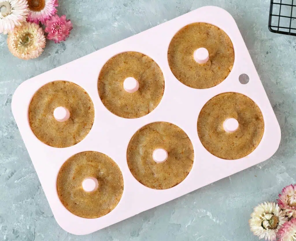 Raw doughnuts pressed into moulds