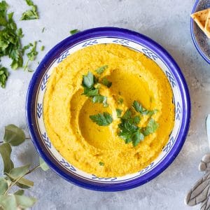 Golden Beetroot Hummus in a blue bowl
