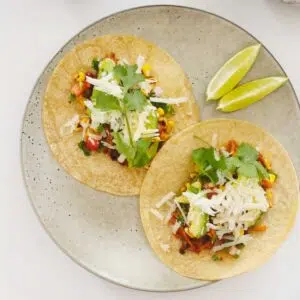 Two mushroom tacos on a plate square image