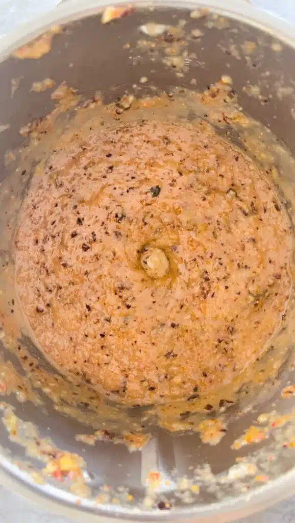 Looking down inside a blender to see fig puree.