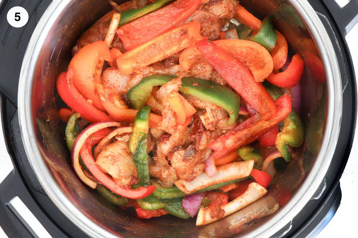 Looking inside and instant pot to see that all the chicken fajita mix has been well combined.