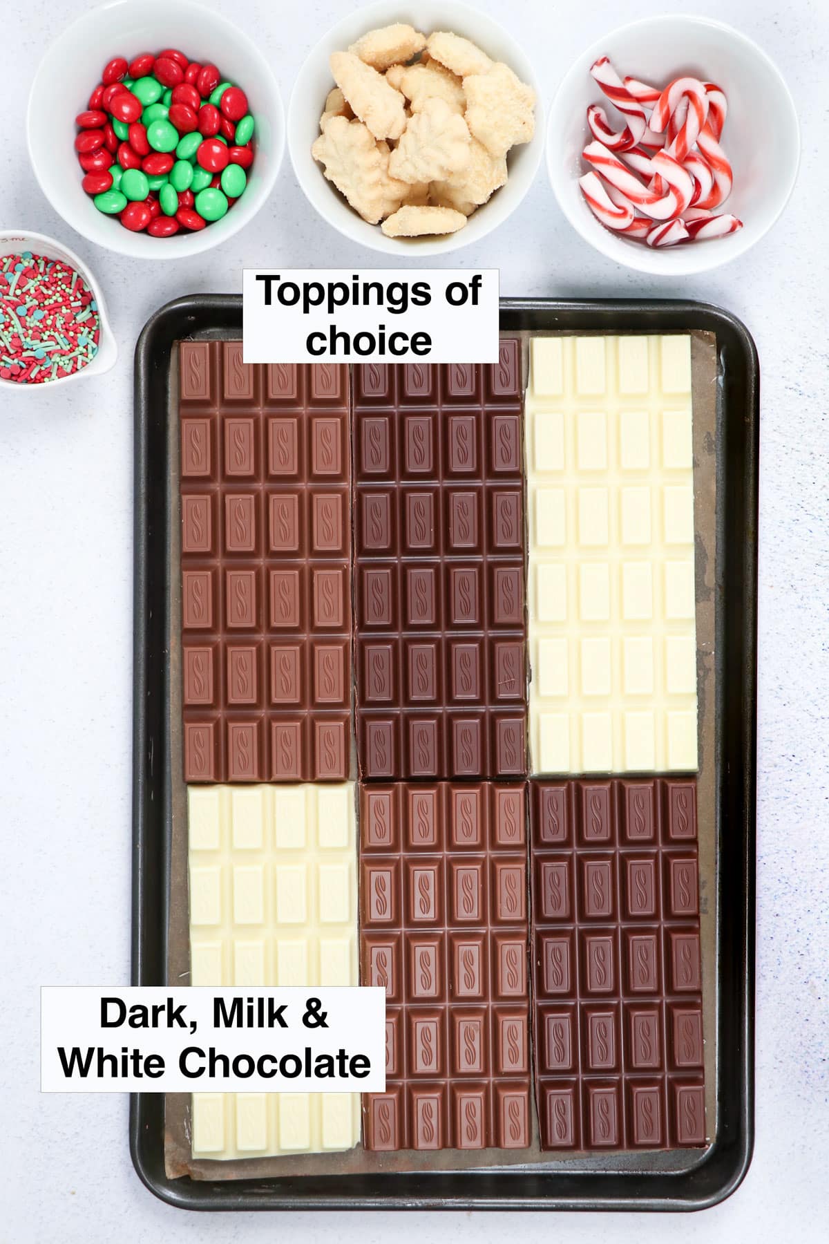 All the ingredients needed to make a chocolate bark recipe are laid out across a table.