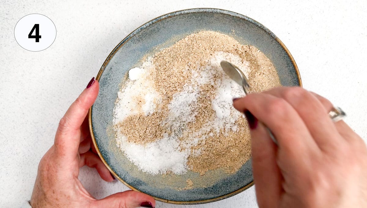 Mushroom powder and sea salt are being mixed together in a small blue bowl.