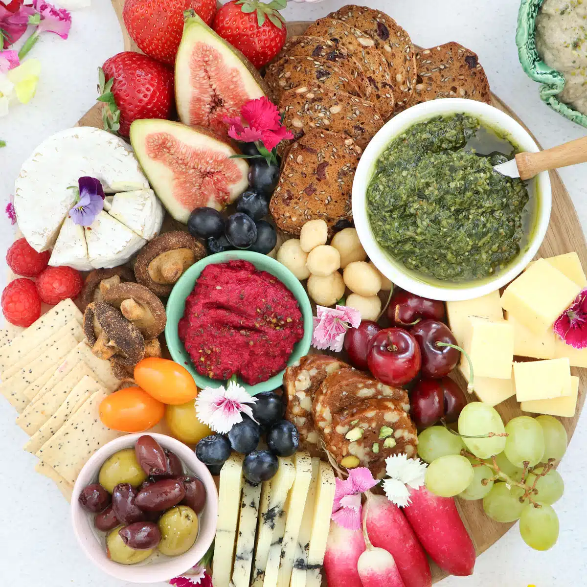 Looking down over a round grazing board filled with an assortment of colourful ingredients.