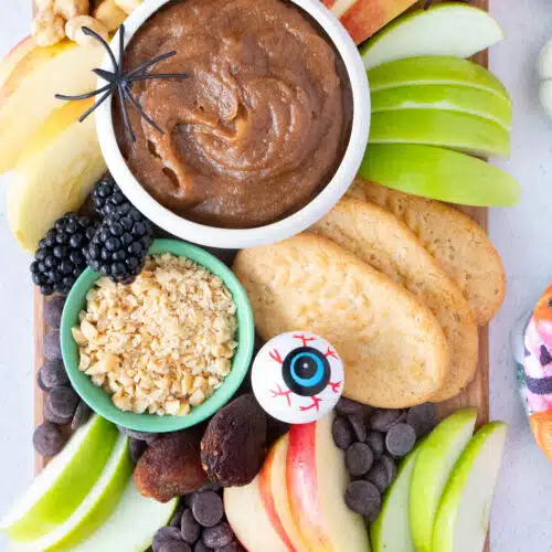 Close up of a variety of ingredients clustered together on a caramel apple charcuterie board.