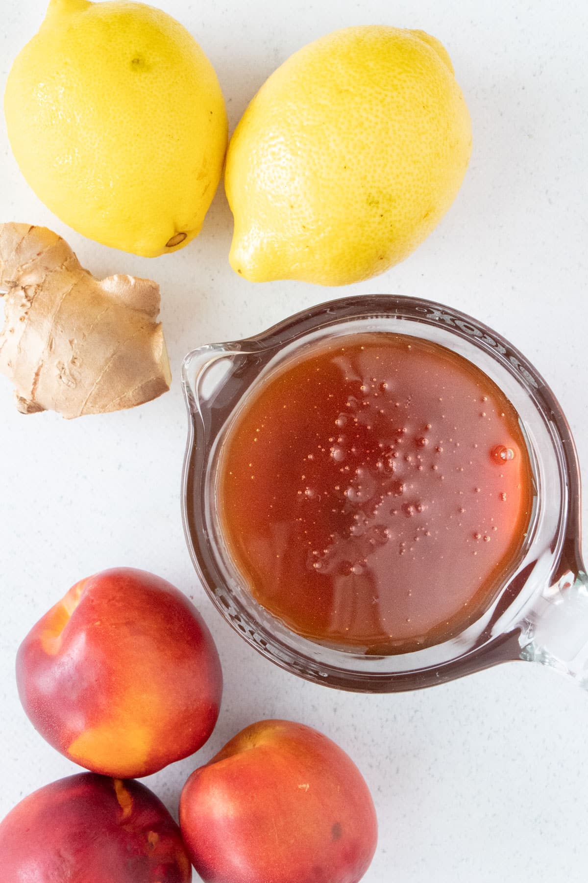 All the ingredients needed to make honey fermented fruit are laid out across a table.