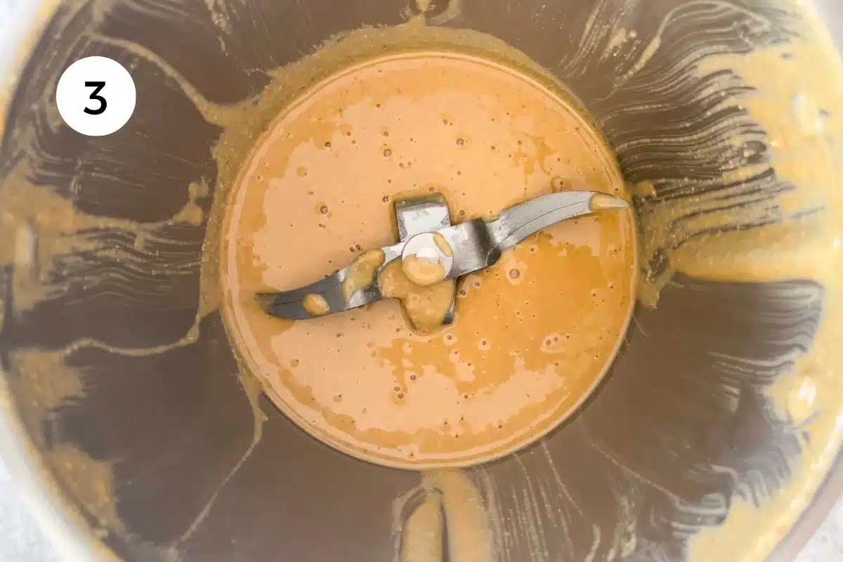 Hazelnuts have been blended into a nut butter, which is still in the blender.