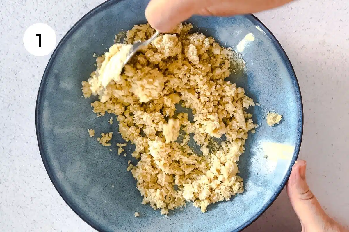 Almond meal is being mixed in a bowl to form a cookie base.