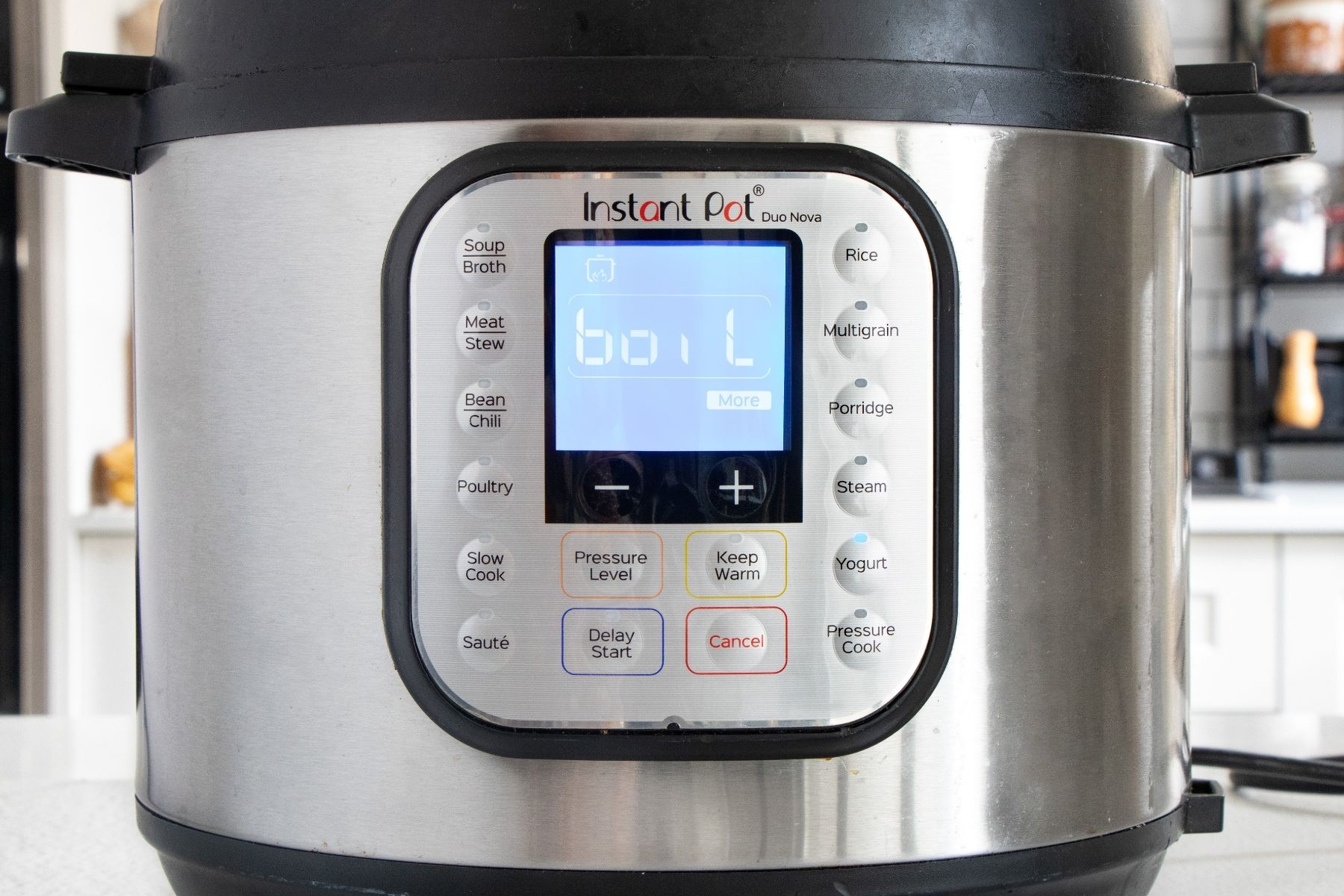 The word boil is showing on the screen of an instant pot and the yogurt button is lit up.