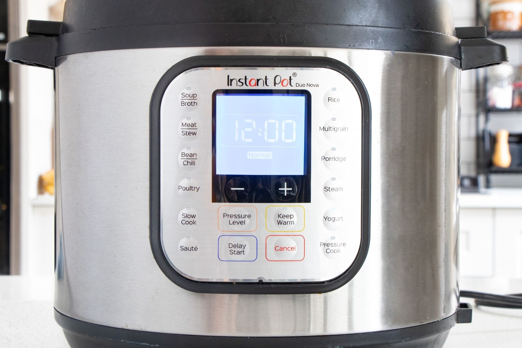 The screen of an instant pot shows 12 hours. The yoghurt button is lit up too.